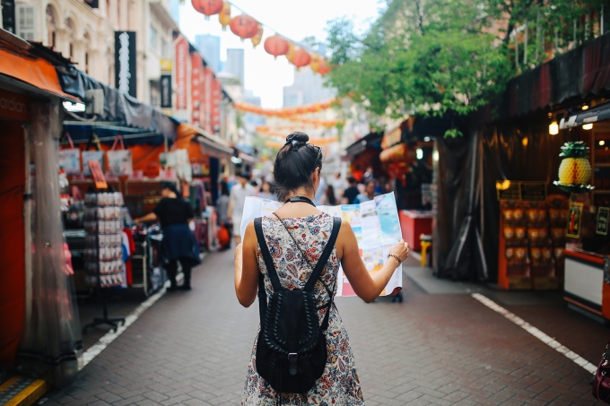 Young woman traveling looking at map