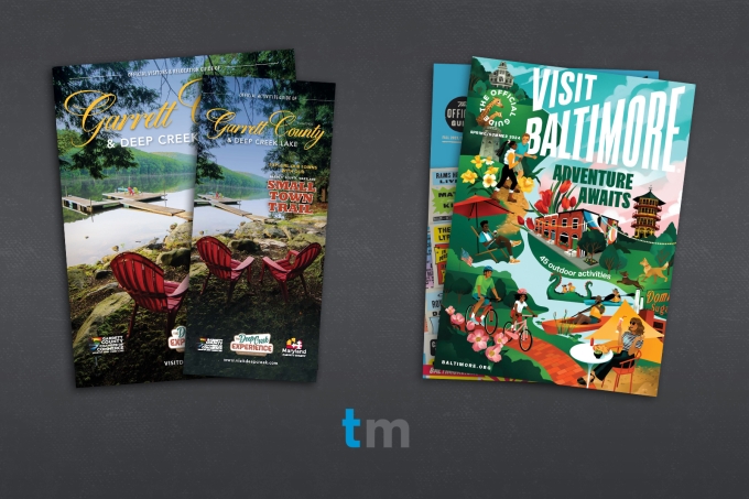 Two sets of a stack of magazine covers. Garrett County Visitors guide on the left, Visit Baltimore magazine on the right.