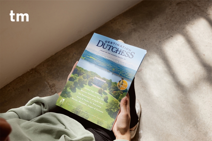 An over-the-shoulder view of a person holding a magazine in their lap.